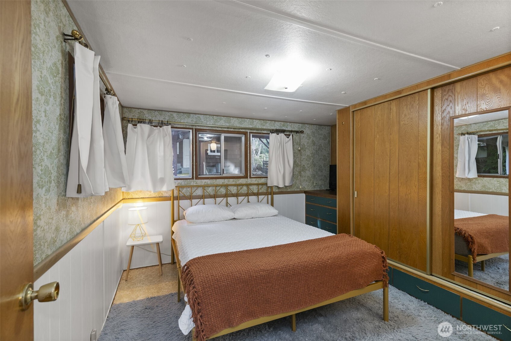 8491 Illahee Road Northeast Bremerton, WA 98311 - Photo 28 of 36 a large bedroom with a bed and large windows