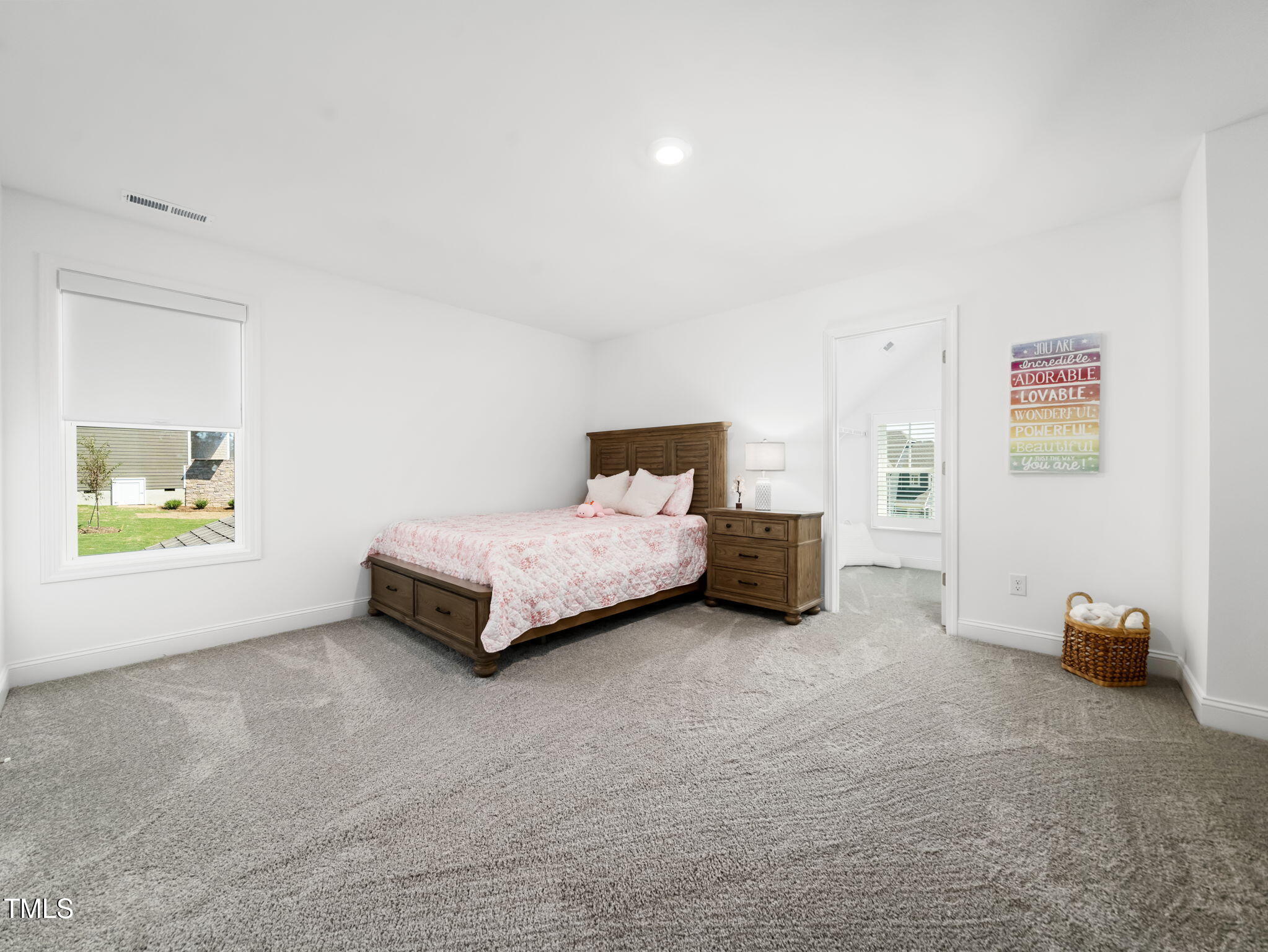 1112 Prominence Drive Durham, NC 27712 - Photo 21 of 40 a spacious bedroom with a bed and a cabinets