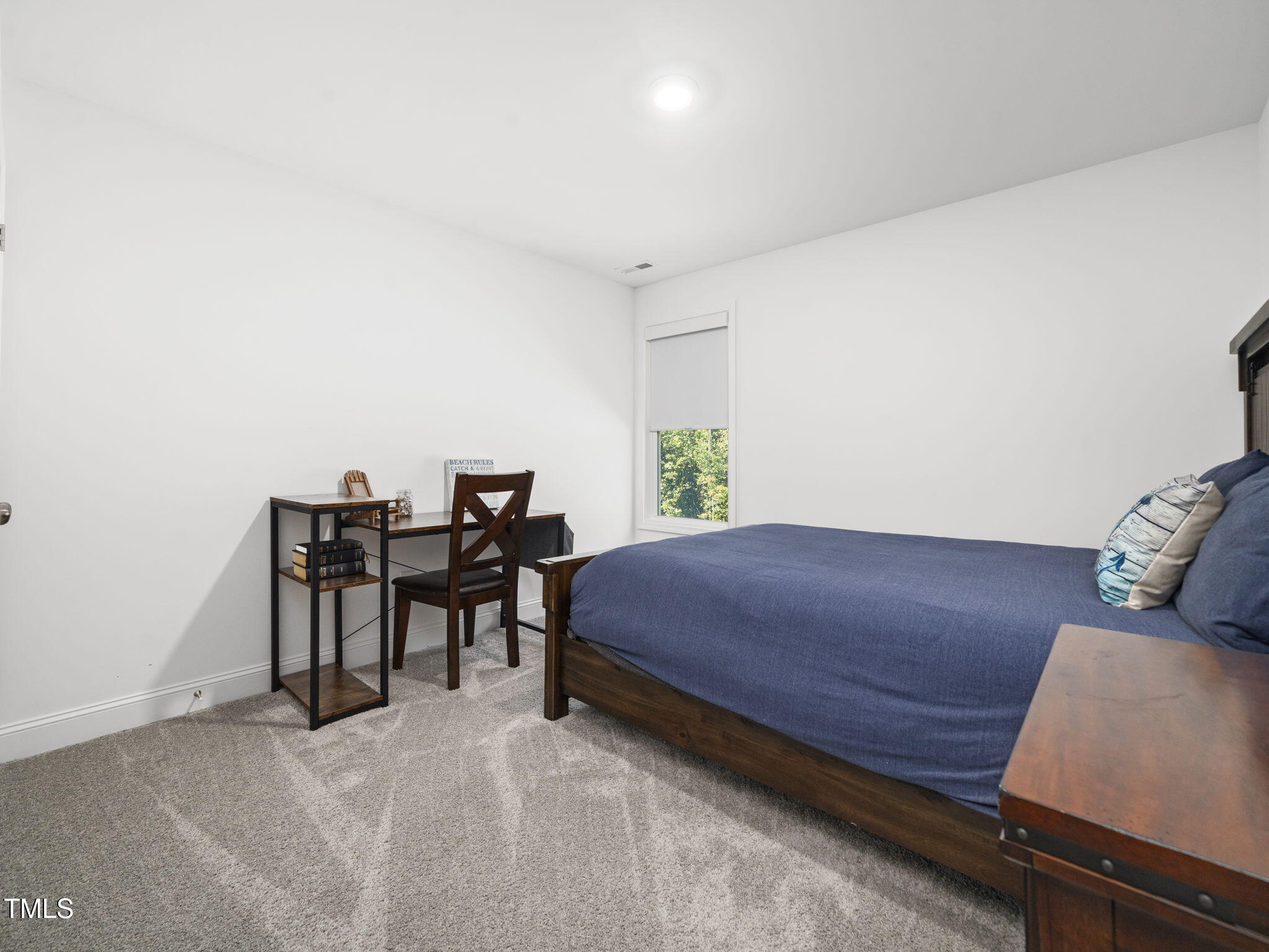 1112 Prominence Drive Durham, NC 27712 - Photo 23 of 40 a bedroom with a bed and a desk