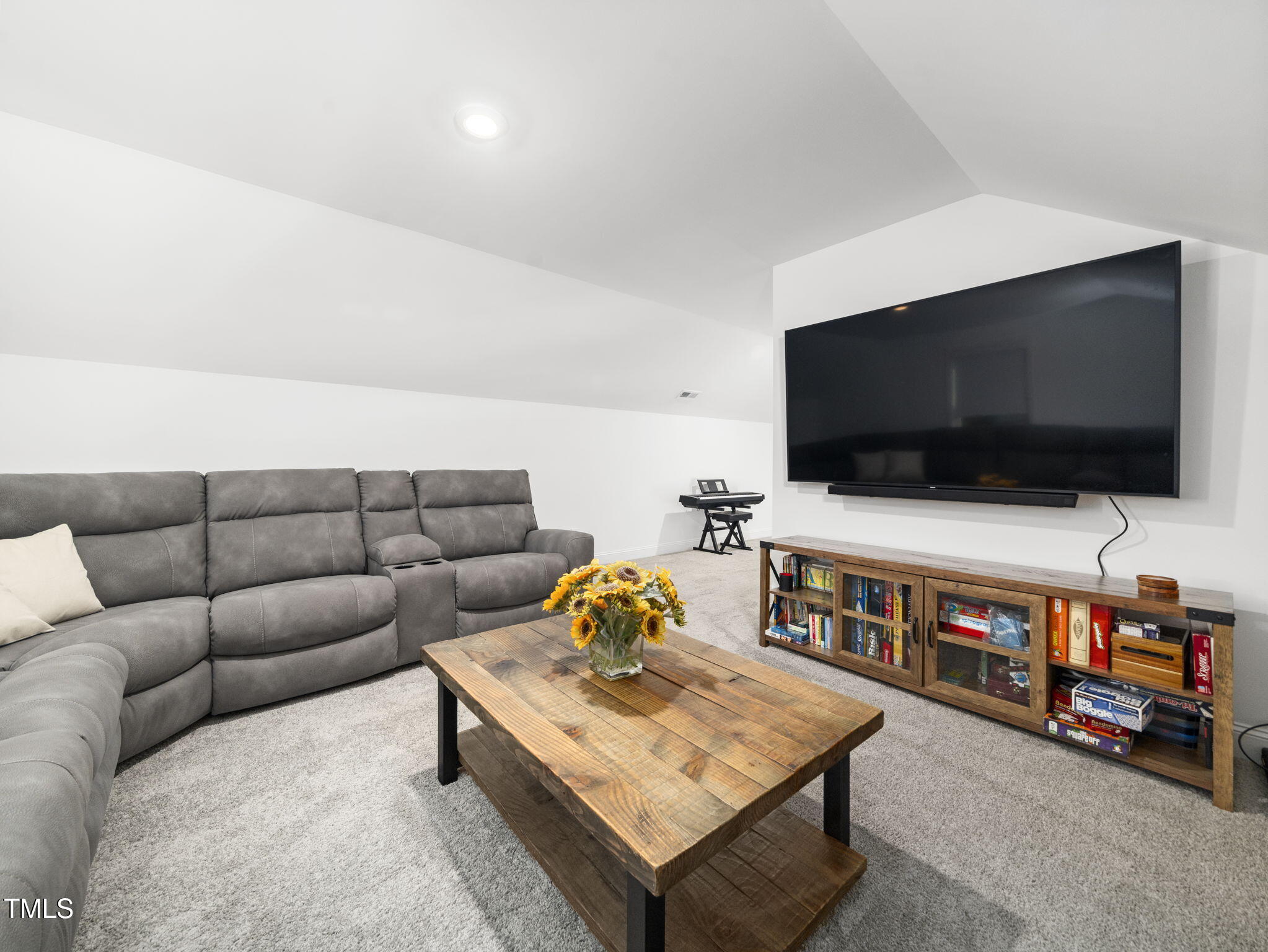 1112 Prominence Drive Durham, NC 27712 - Photo 26 of 40 a living room with furniture and a flat screen tv