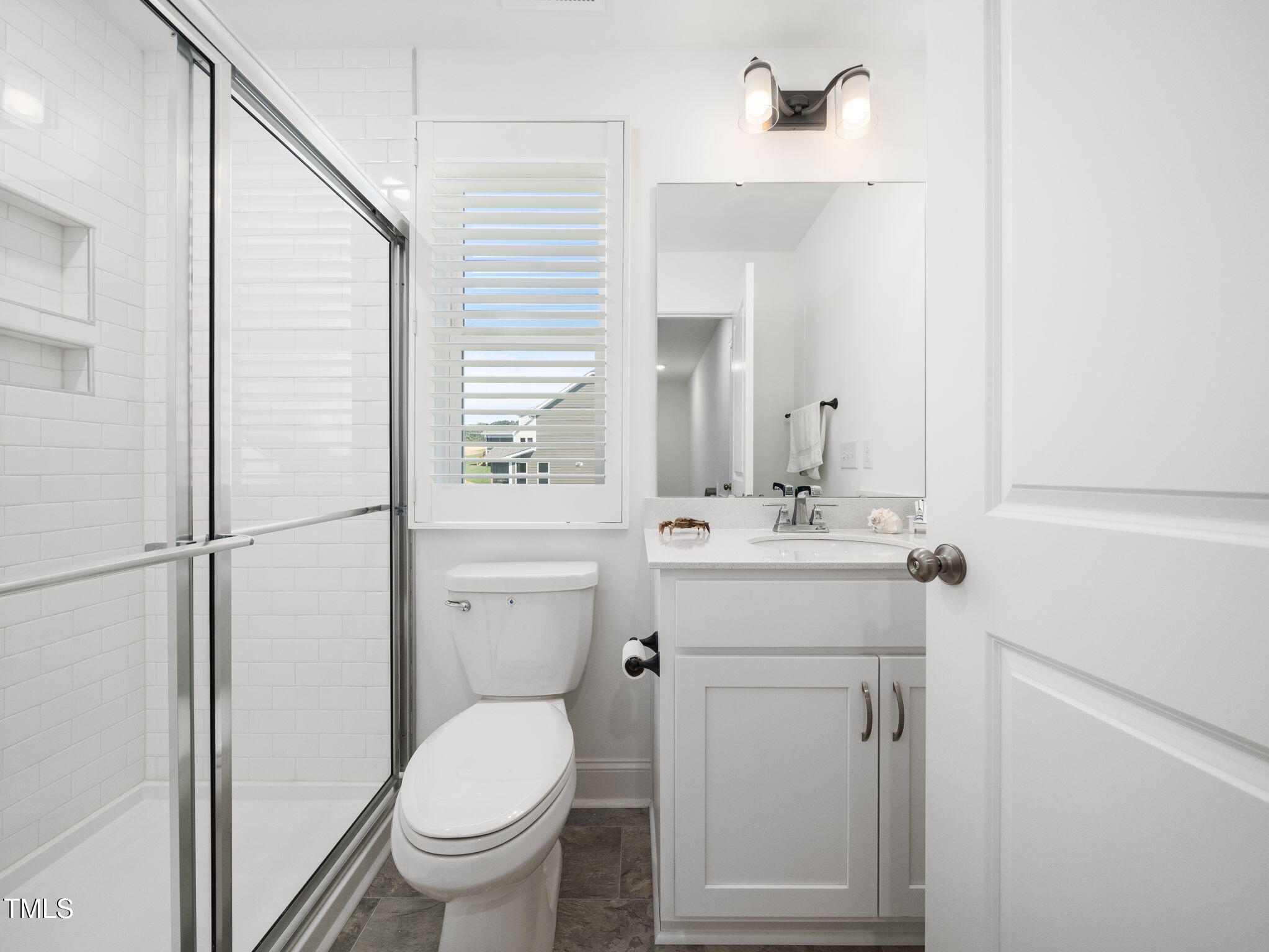 1112 Prominence Drive Durham, NC 27712 - Photo 29 of 40 a bathroom with a toilet sink vanity and mirror