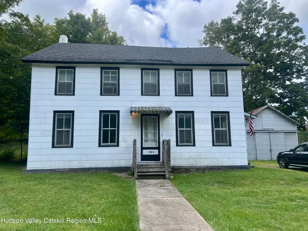 a view of a house with a yard
