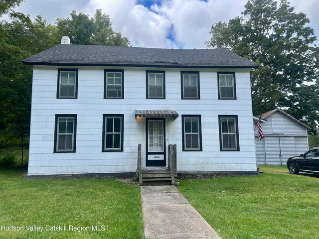a view of a house with a yard