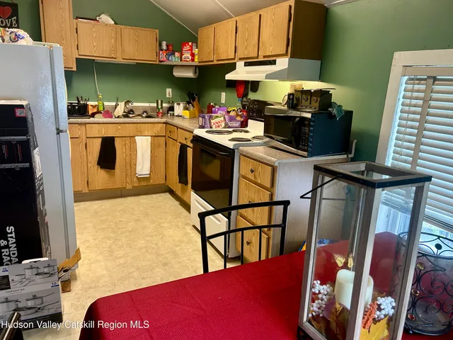 a kitchen with stainless steel appliances granite countertop a stove refrigerator and a microwave