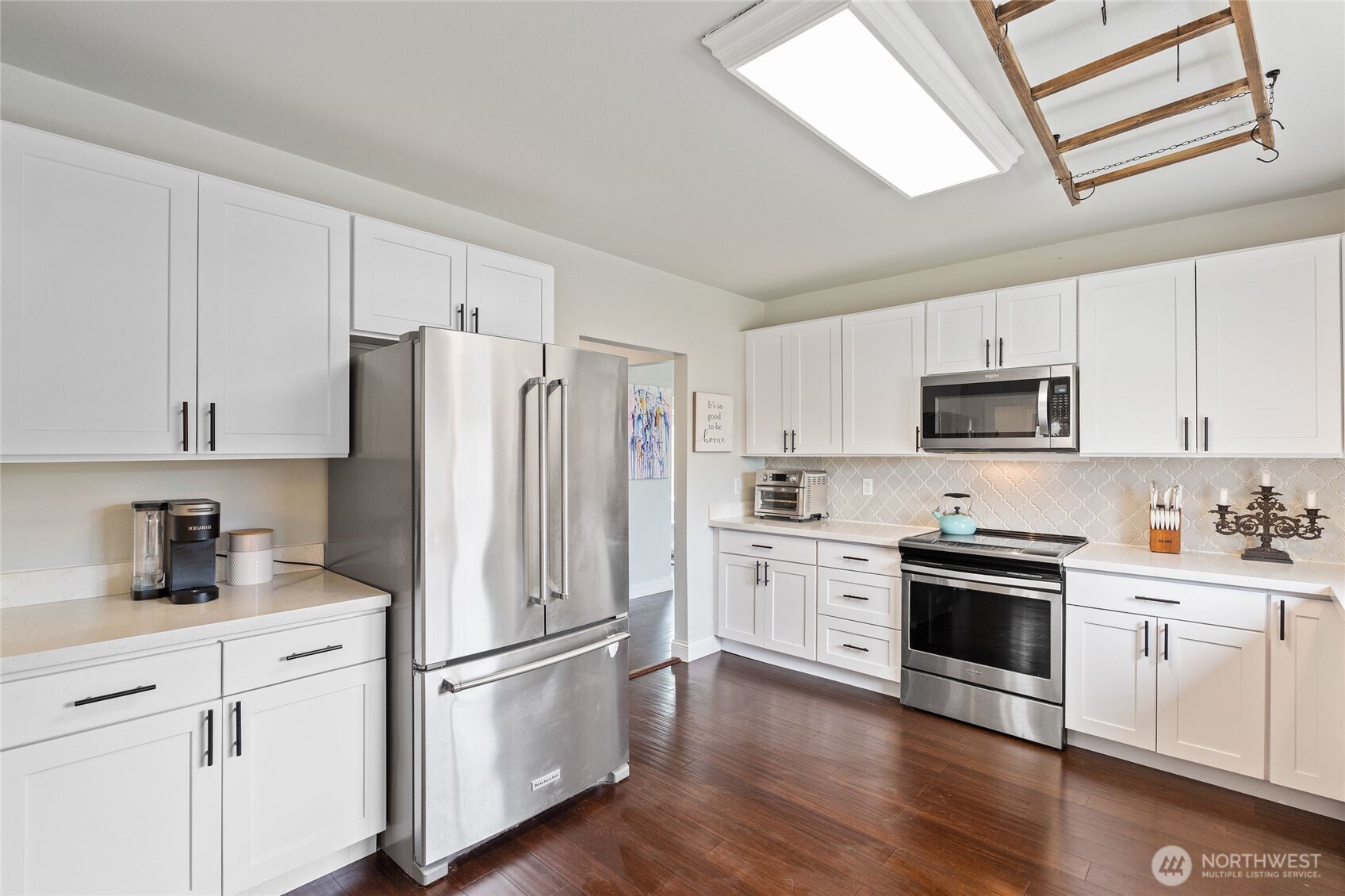 11 R Street Southeast Auburn, WA 98002 - Photo 11 of 38 a kitchen with white cabinets and stainless steel appliances