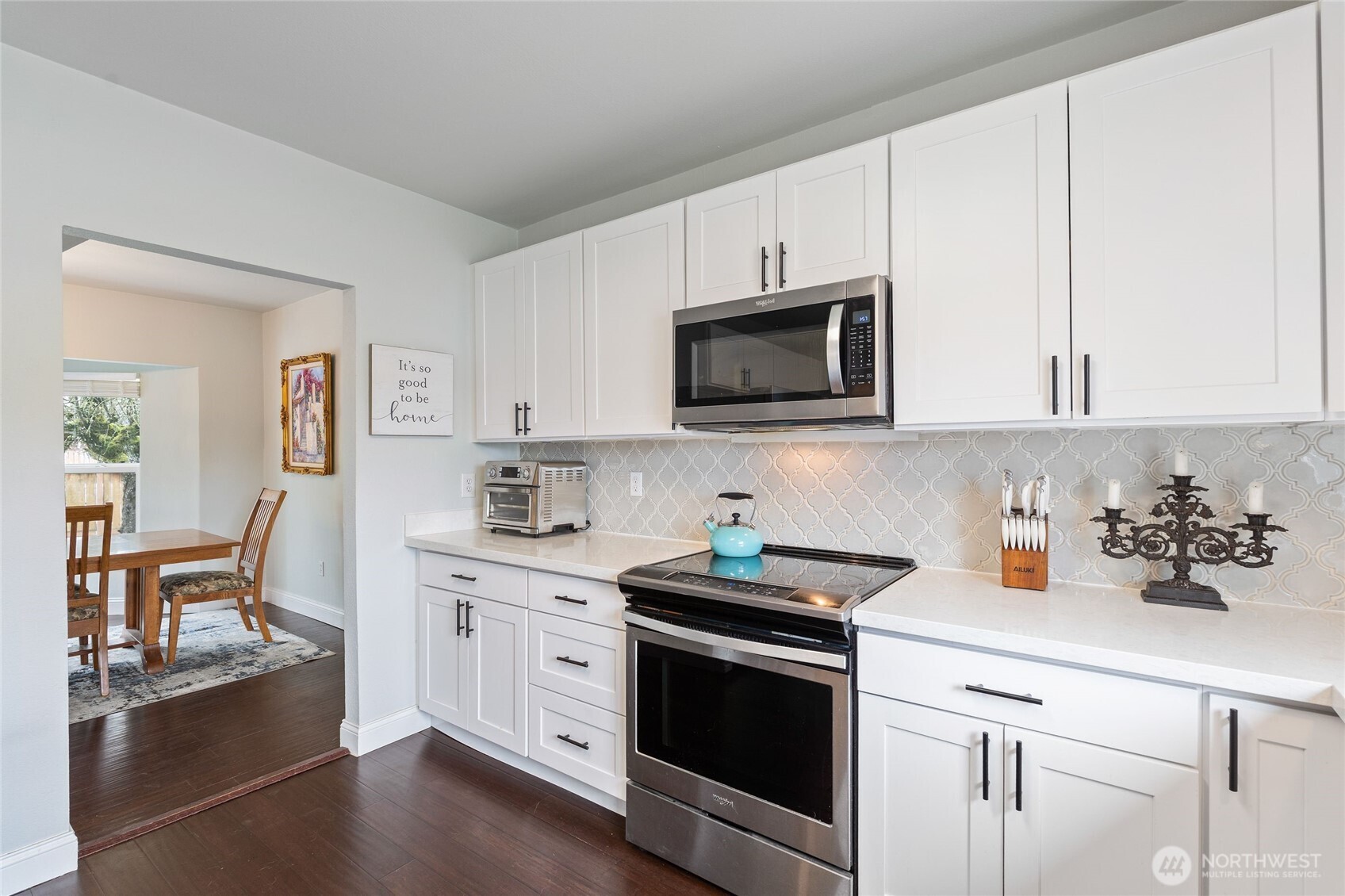 11 R Street Southeast Auburn, WA 98002 - Photo 12 of 38 a kitchen with cabinets stainless steel appliances and wooden floor