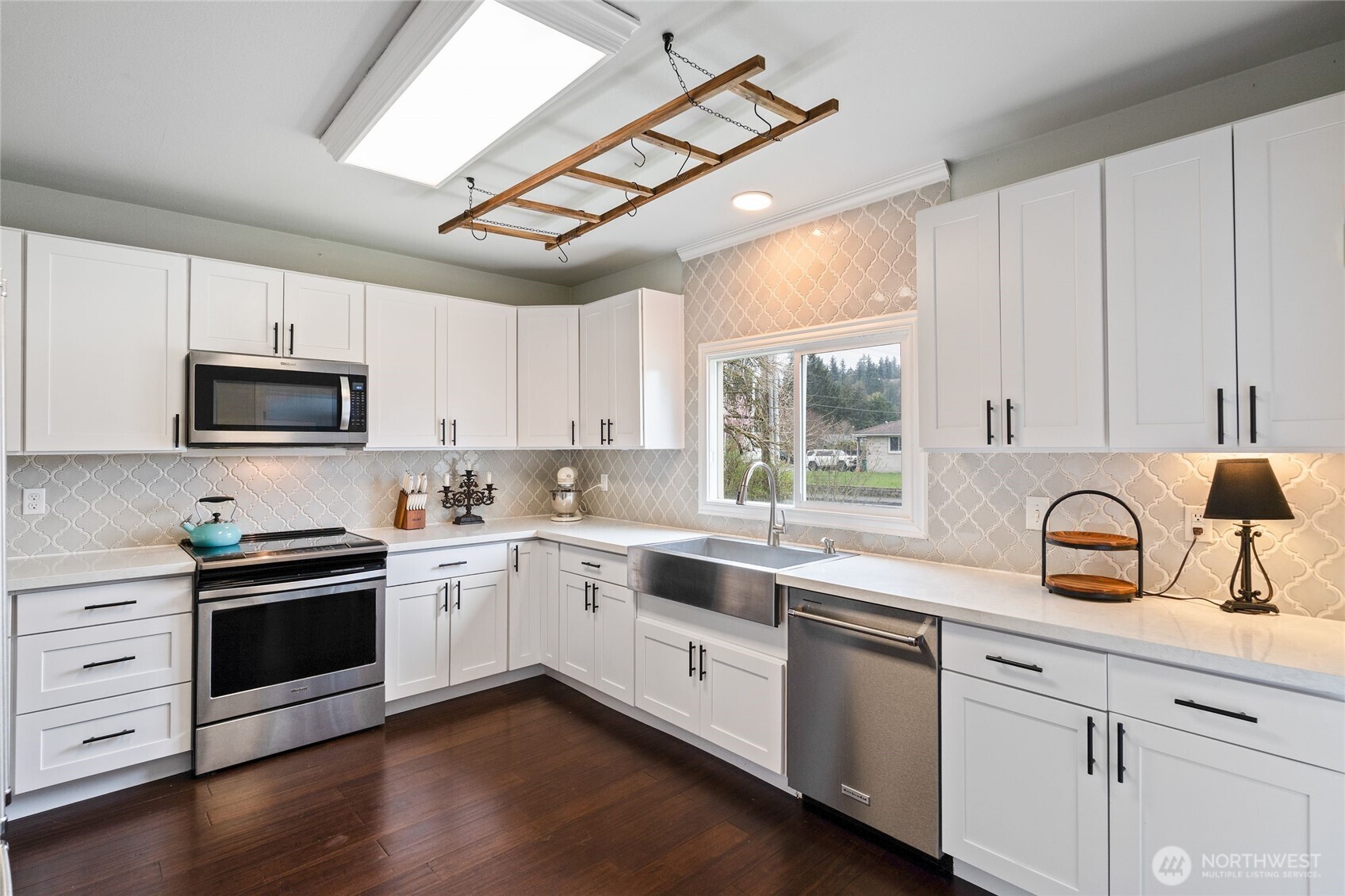 11 R Street Southeast Auburn, WA 98002 - Photo 13 of 38 a kitchen with a sink cabinets appliances and a window