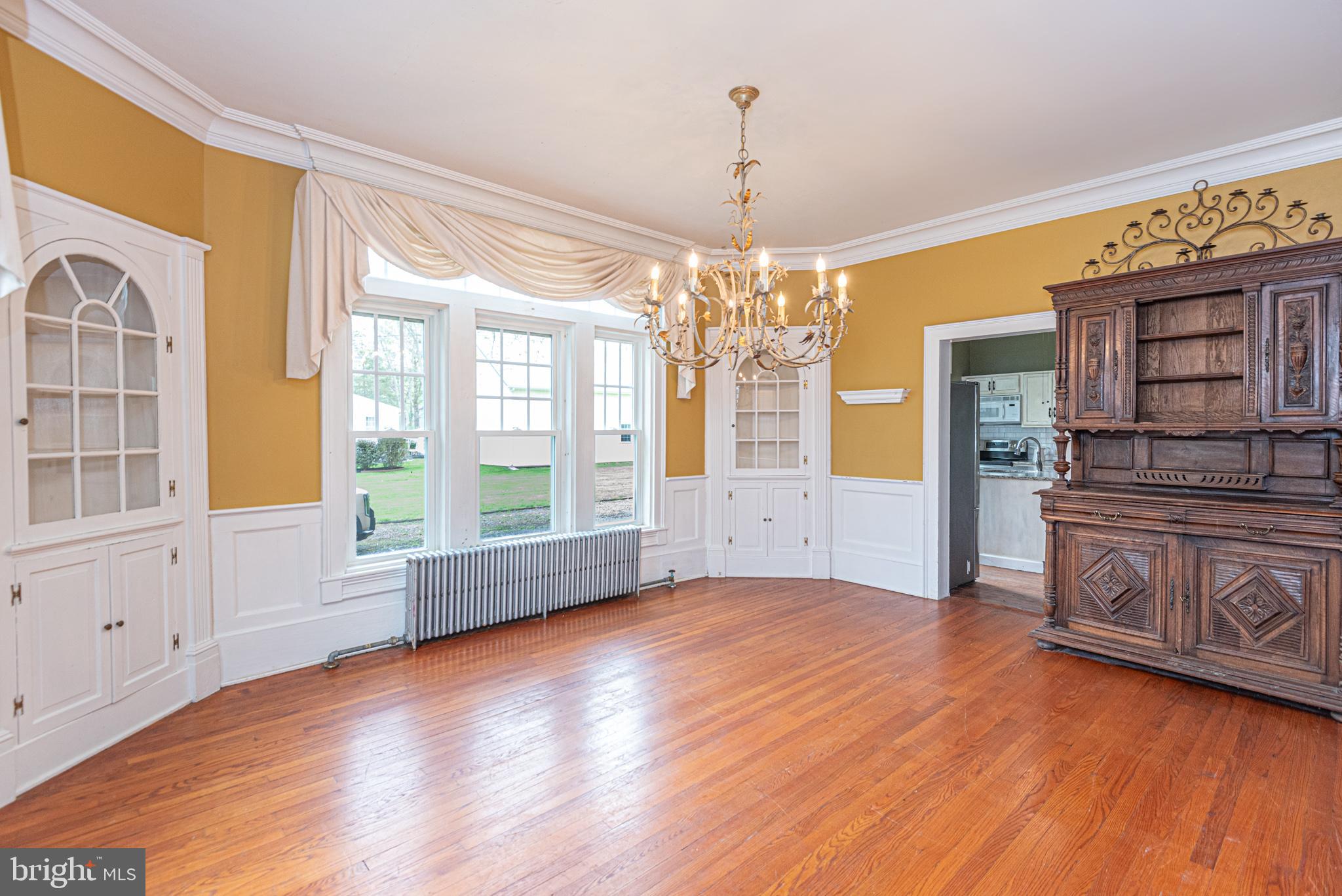 8318 Langmaid Road Newark, MD 21841 - Photo 11 of 122 a view of an empty room with wooden floor and a window