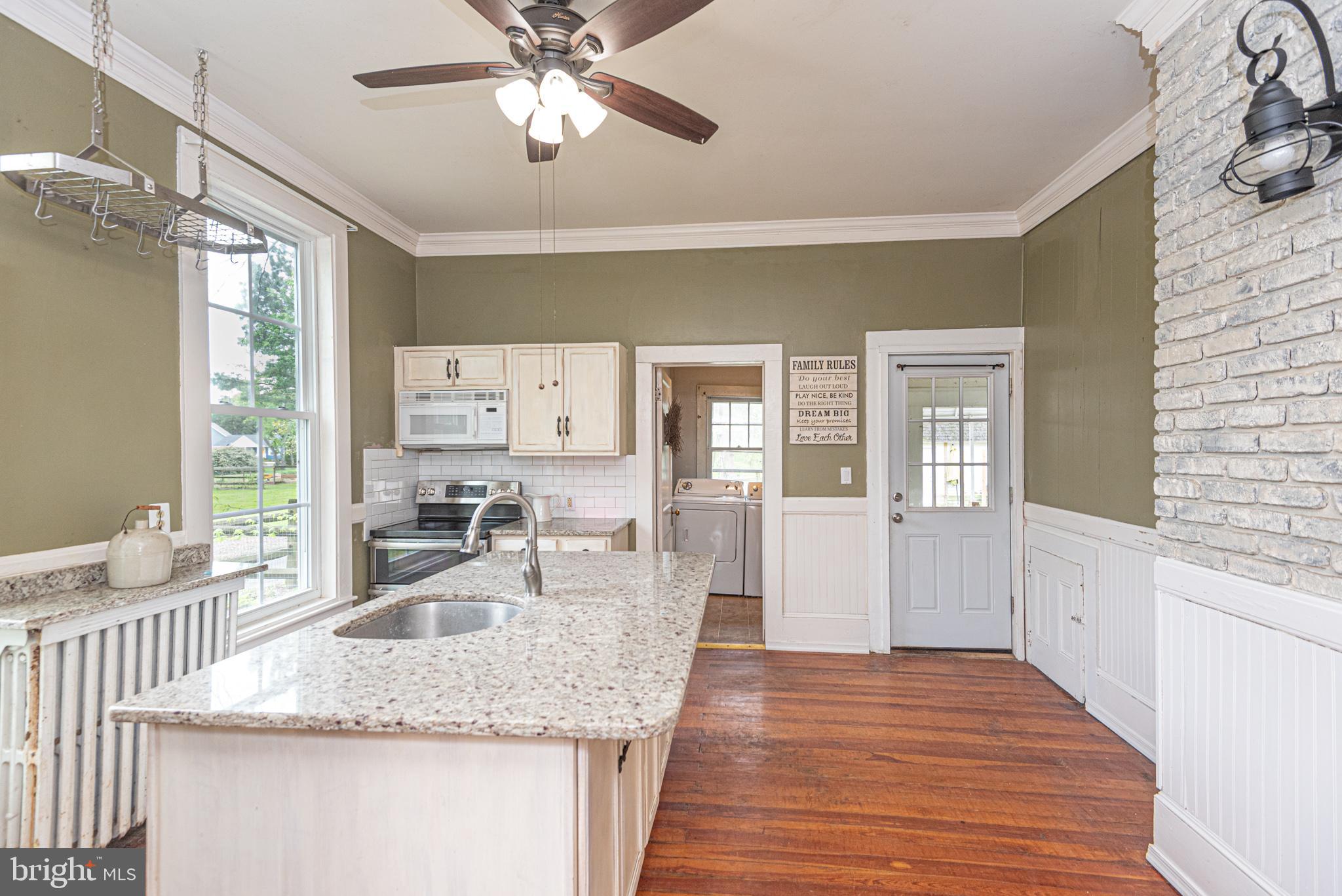 8318 Langmaid Road Newark, MD 21841 - Photo 15 of 122 a kitchen with sink refrigerator and window
