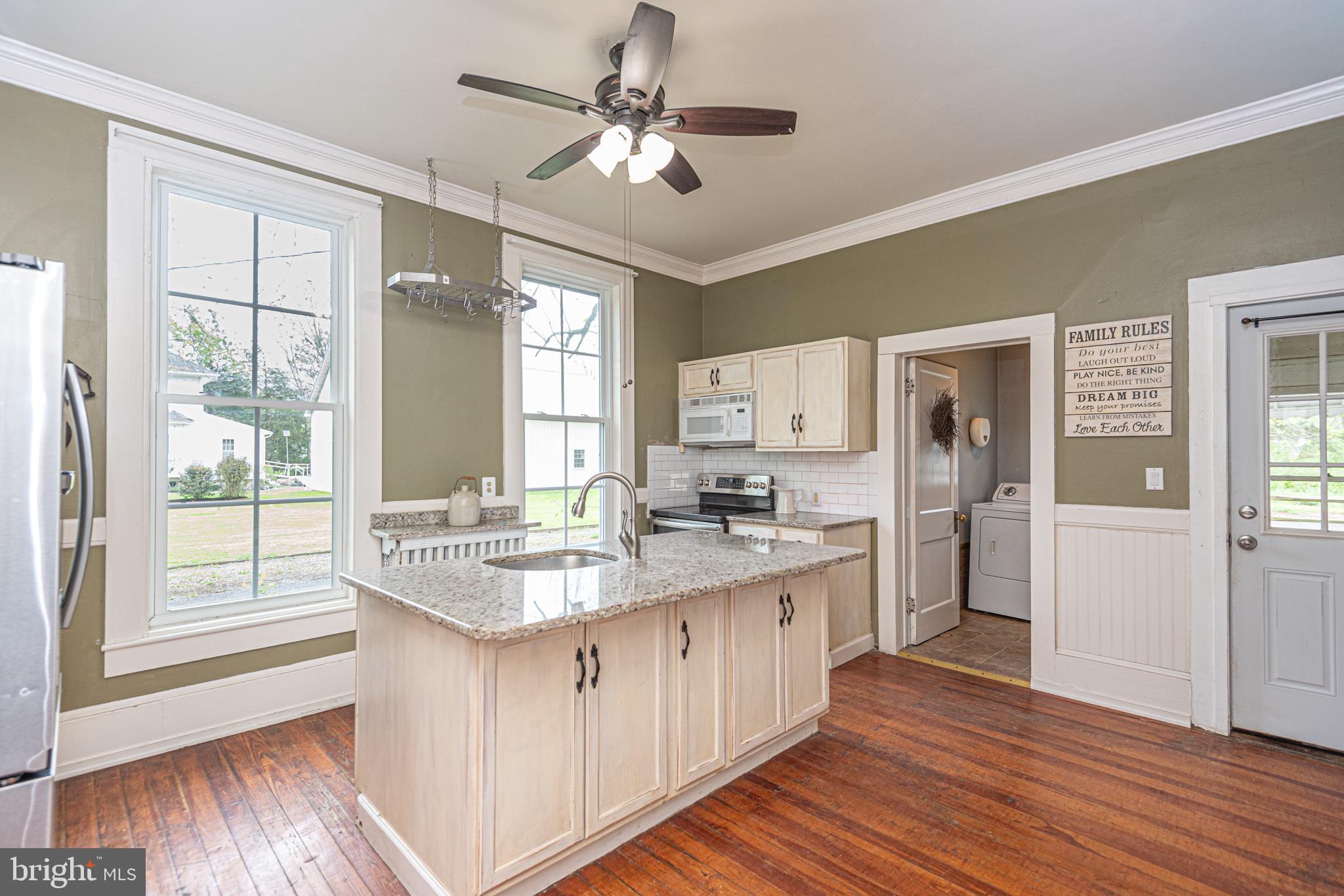 8318 Langmaid Road Newark, MD 21841 - Photo 16 of 122 a kitchen with sink cabinets and wooden floor