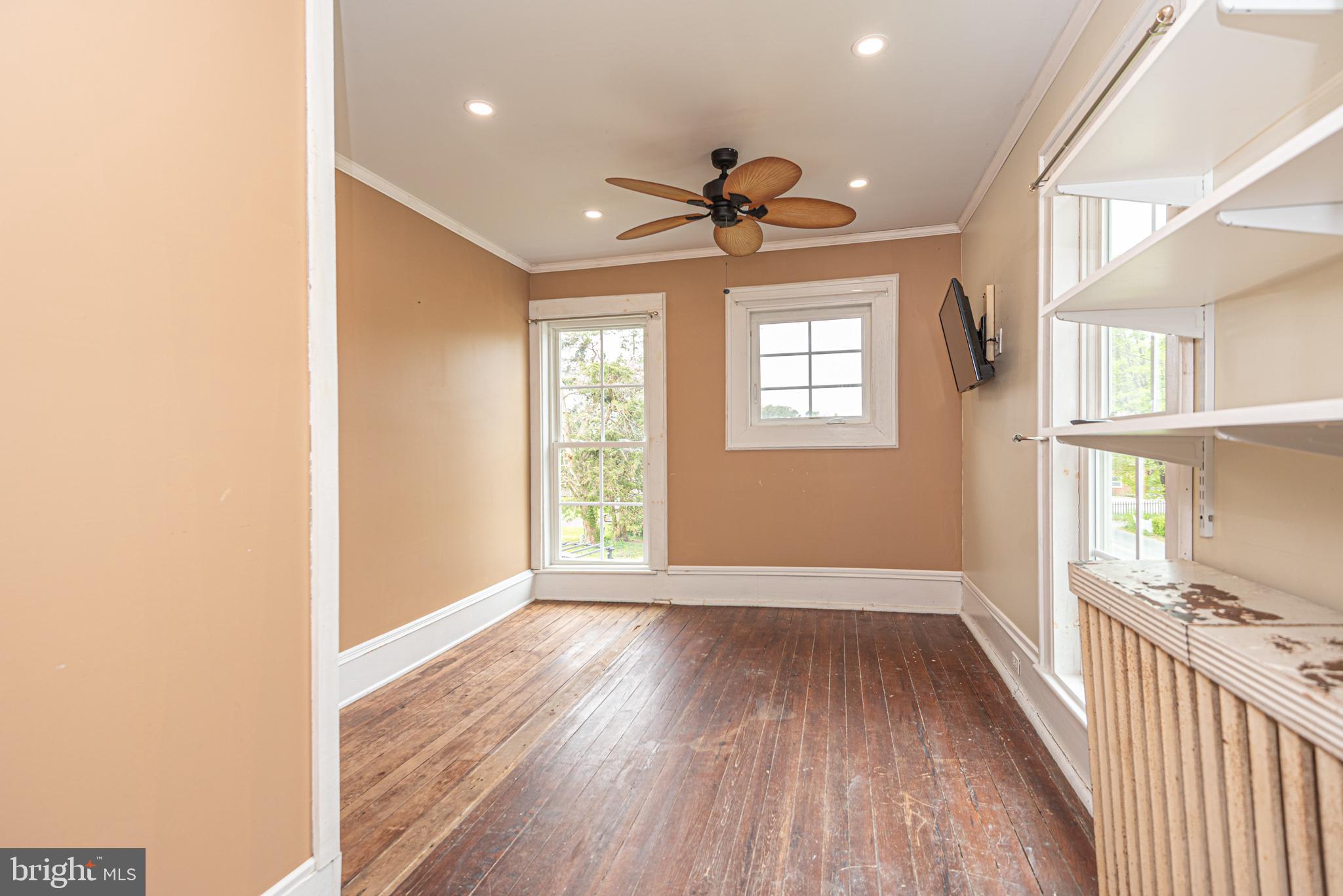 8318 Langmaid Road Newark, MD 21841 - Photo 49 of 122 a view of hallway with wooden floor and a window