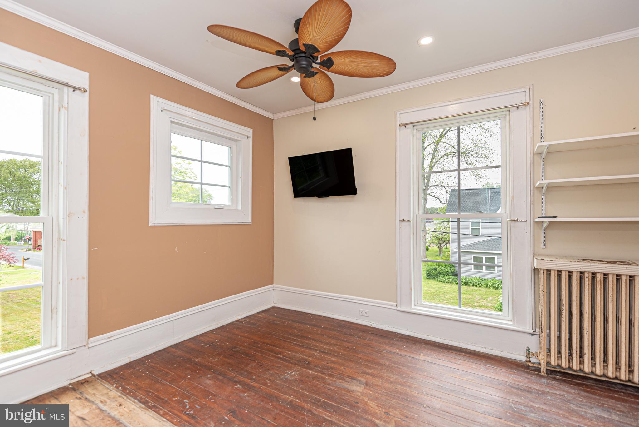 8318 Langmaid Road Newark, MD 21841 - Photo 52 of 122 a view of an empty room with a window and wooden floor