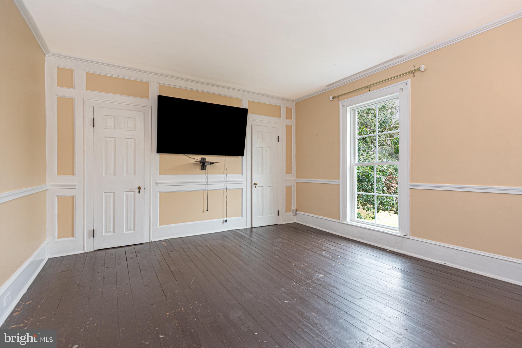 8318 Langmaid Road Newark, MD 21841 - Photo 58 of 122 a view of a livingroom with wooden floor and a flat screen tv
