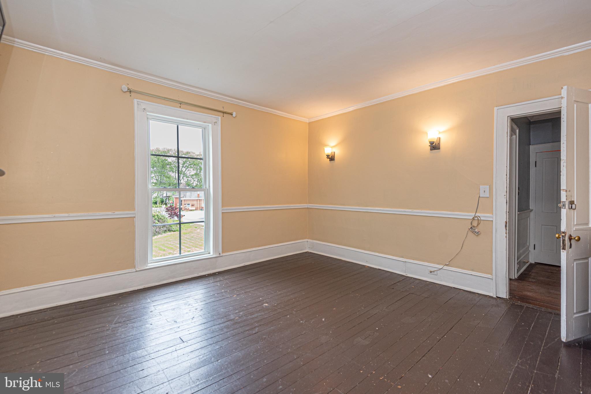 8318 Langmaid Road Newark, MD 21841 - Photo 59 of 122 an empty room with wooden floor and windows