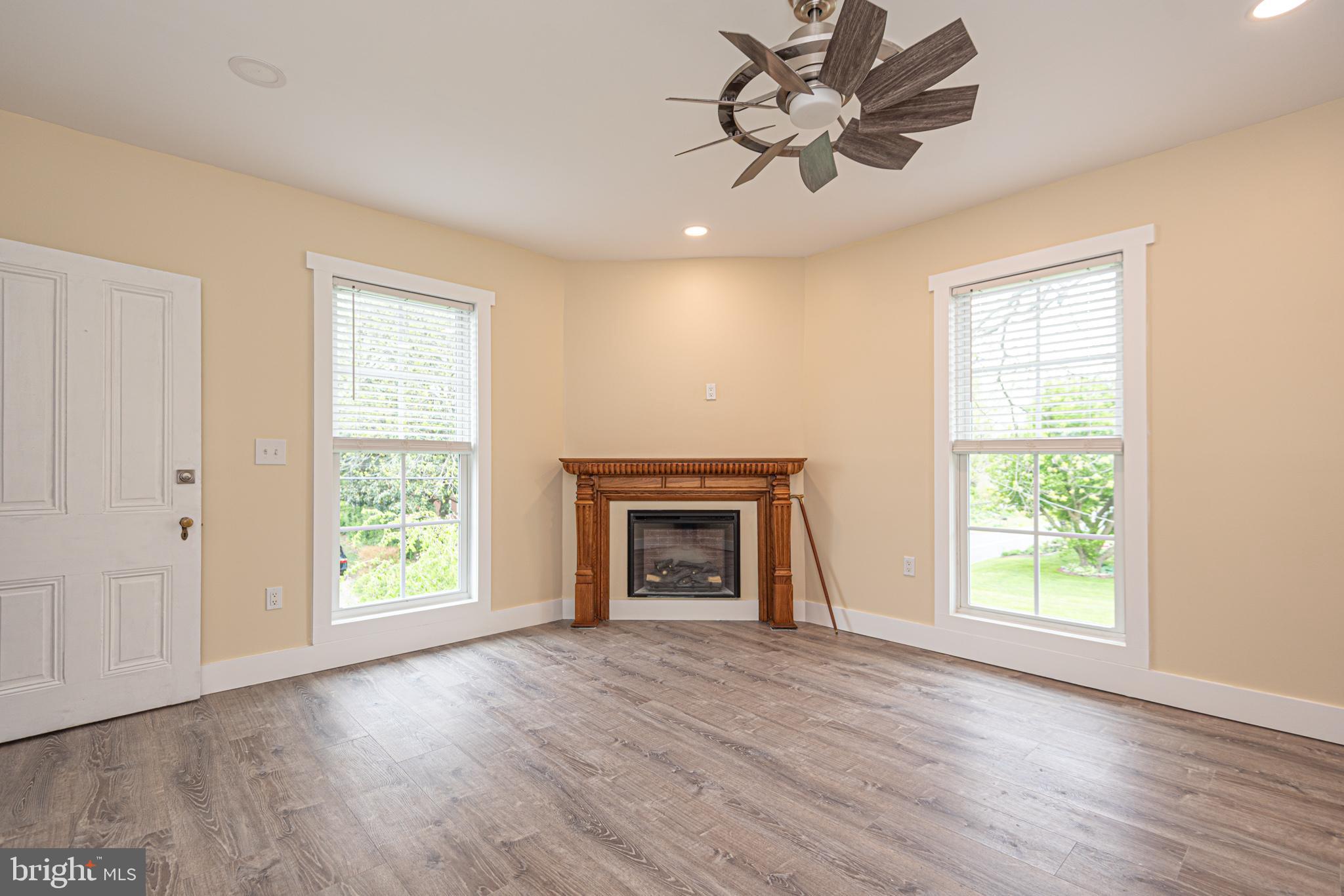 8318 Langmaid Road Newark, MD 21841 - Photo 72 of 122 a view of an empty room with a window and fireplace