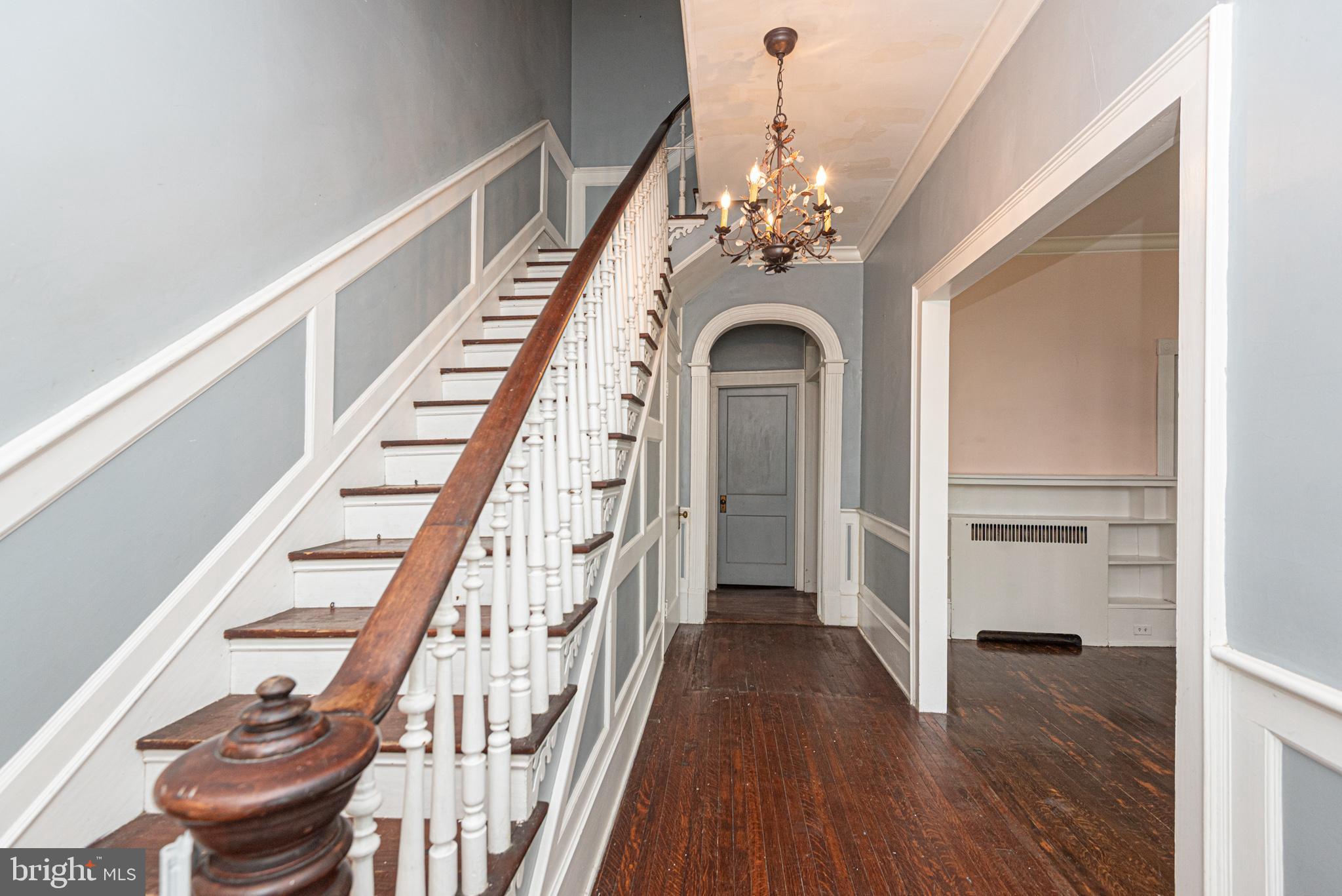 8318 Langmaid Road Newark, MD 21841 - Photo 9 of 122 a view of a hallway with wooden floor and staircase