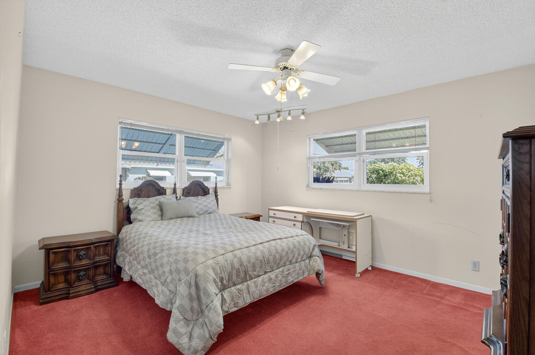634 Hummingbird Lane Delray Beach, FL 33445 - Photo 19 of 37 a bedroom with a bed and a chandelier