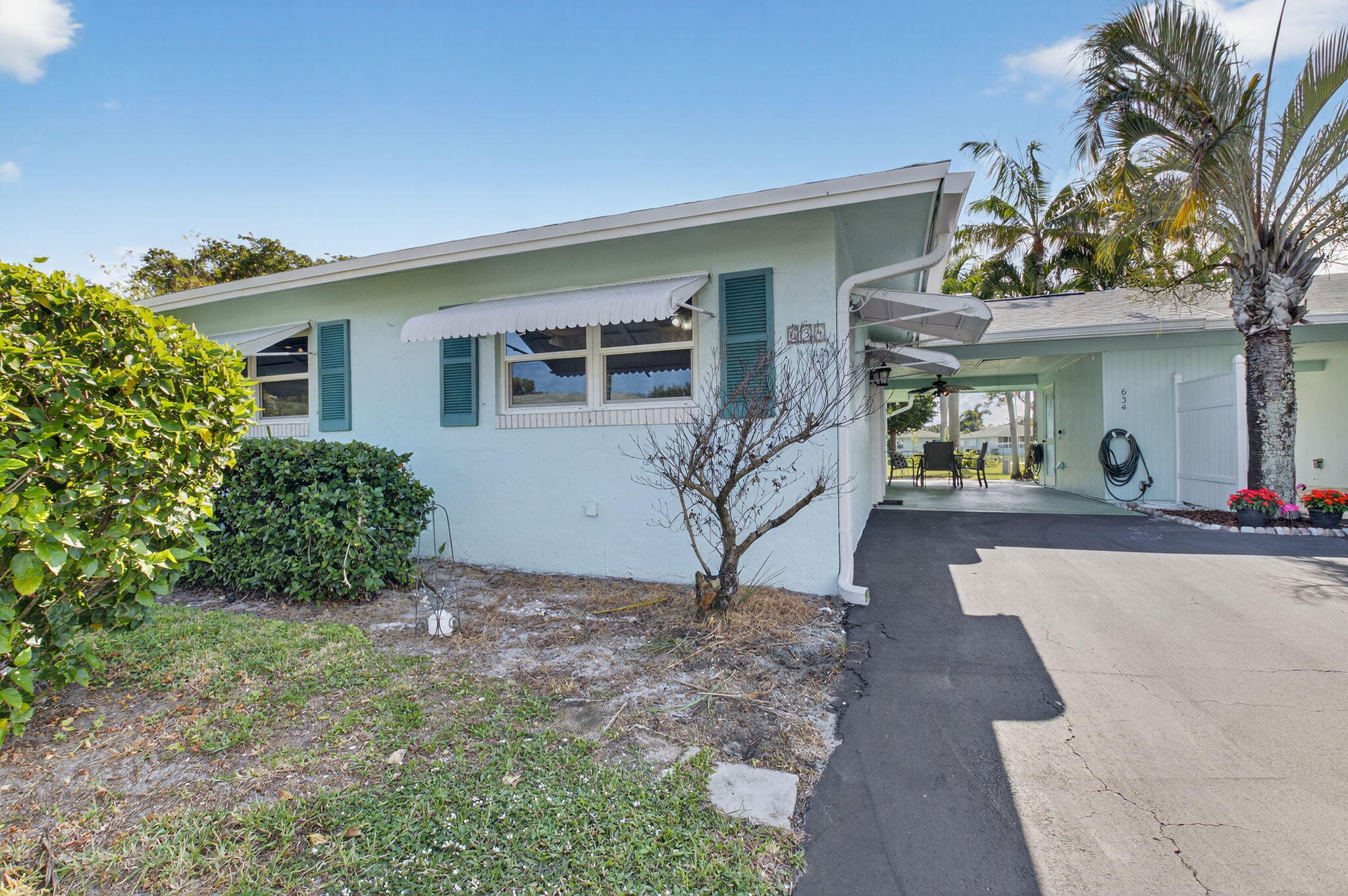 634 Hummingbird Lane Delray Beach, FL 33445 - Photo 2 of 37 a view of a house with porch and garden