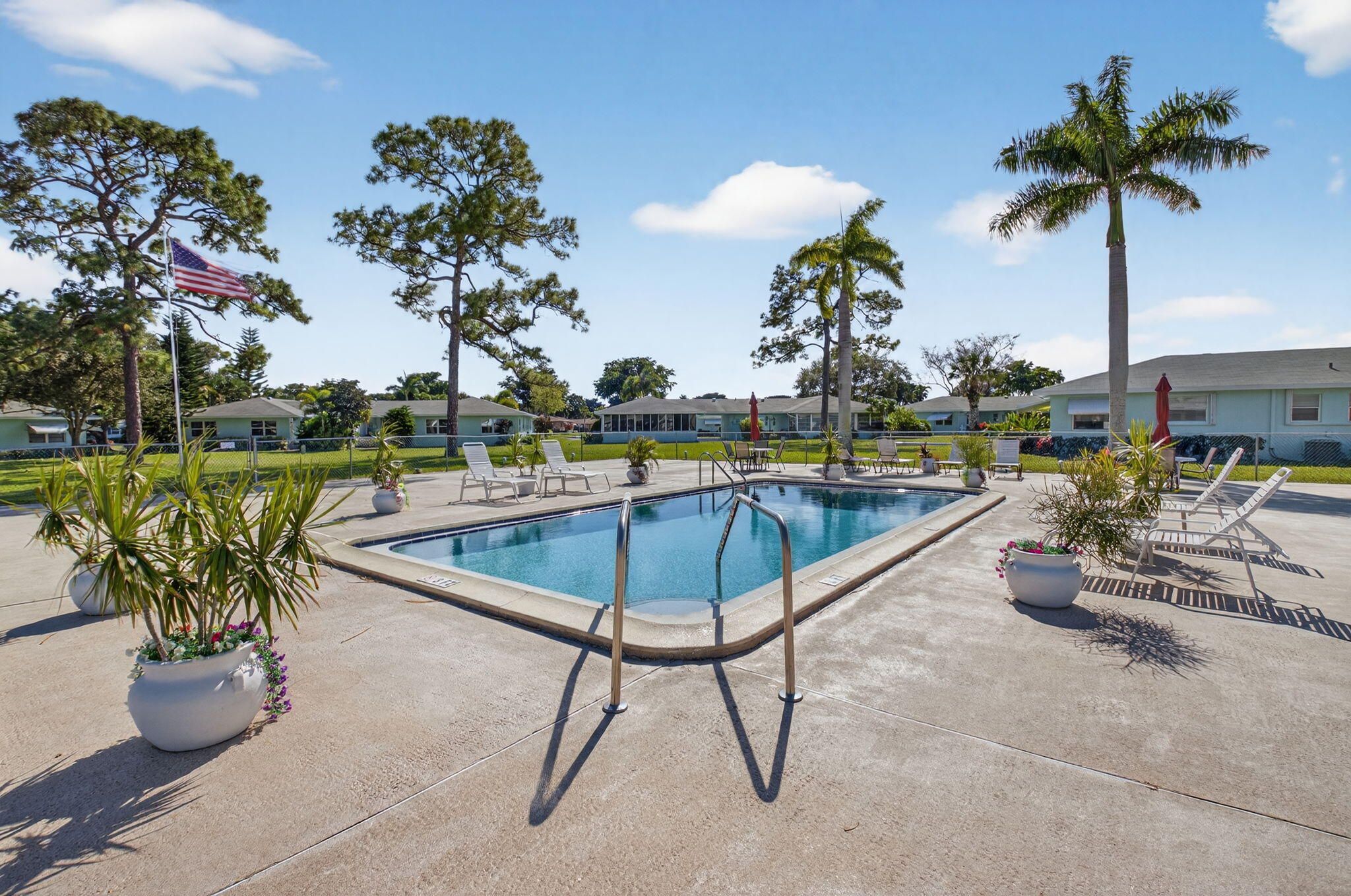 634 Hummingbird Lane Delray Beach, FL 33445 - Photo 26 of 37 a swimming pool with outdoor seating and yard
