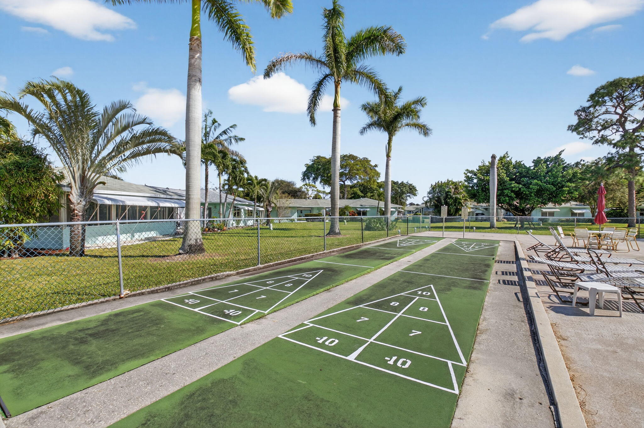 634 Hummingbird Lane Delray Beach, FL 33445 - Photo 27 of 37 a view of a swimming pool with a yard and palm trees