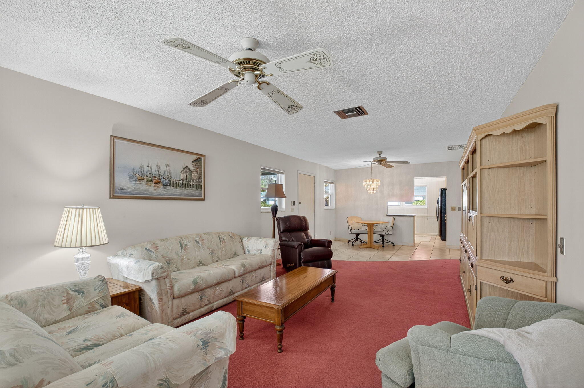 634 Hummingbird Lane Delray Beach, FL 33445 - Photo 9 of 37 a living room with furniture and a lamp