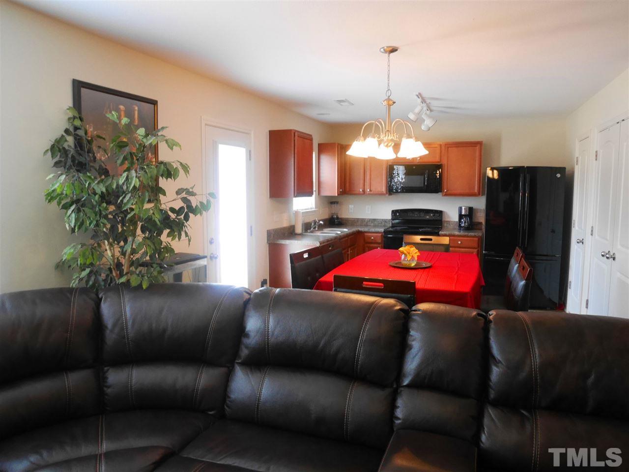2709 Manthorp Terrace Raleigh, NC 27610 - Photo 5 of 21 a living room with furniture and a chandelier