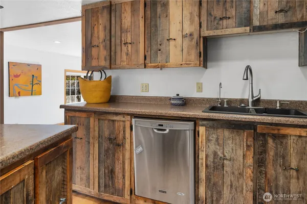 a kitchen with stainless steel appliances granite countertop a sink stove and cabinets