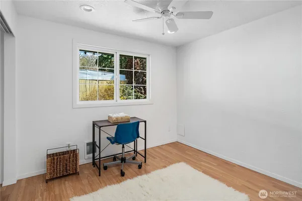 a view of a workspace with furniture and a window