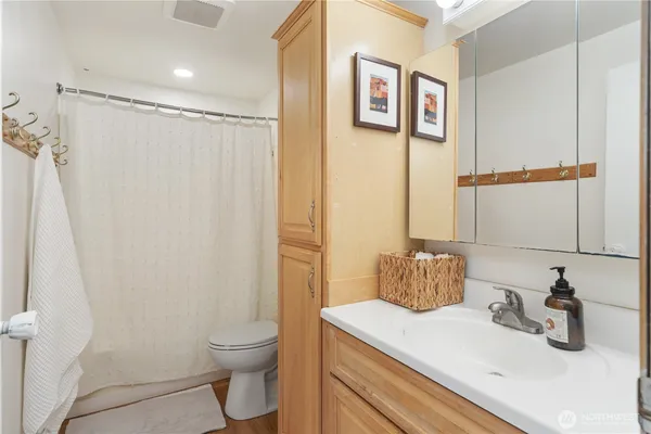a bathroom with a sink toilet and shower
