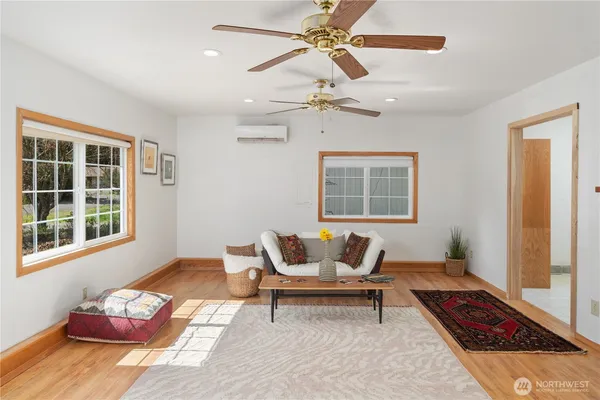 a living room with furniture and wooden floor