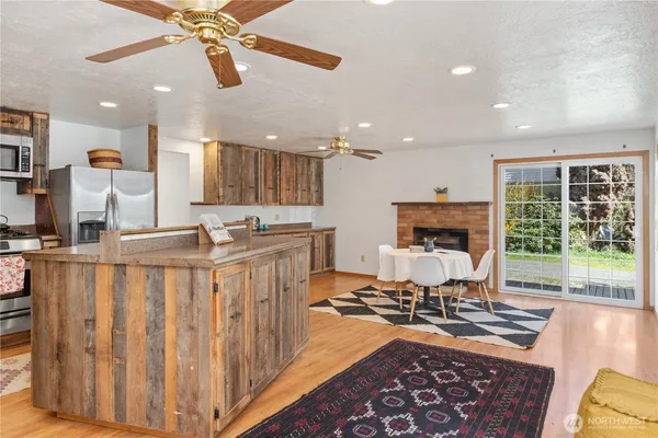 a living room with furniture a fireplace and a chandelier