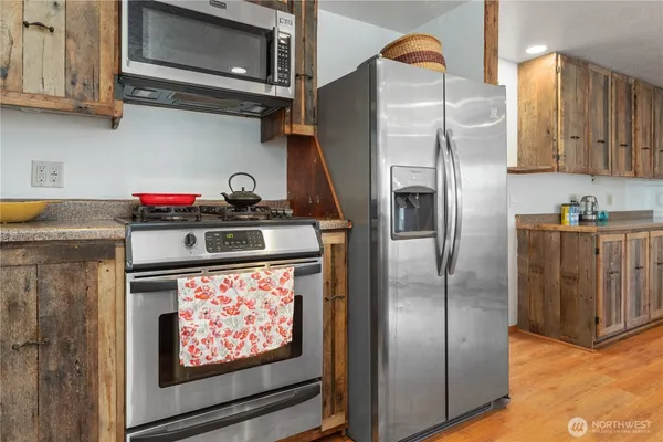 a kitchen with stainless steel appliances granite countertop a refrigerator stove and sink