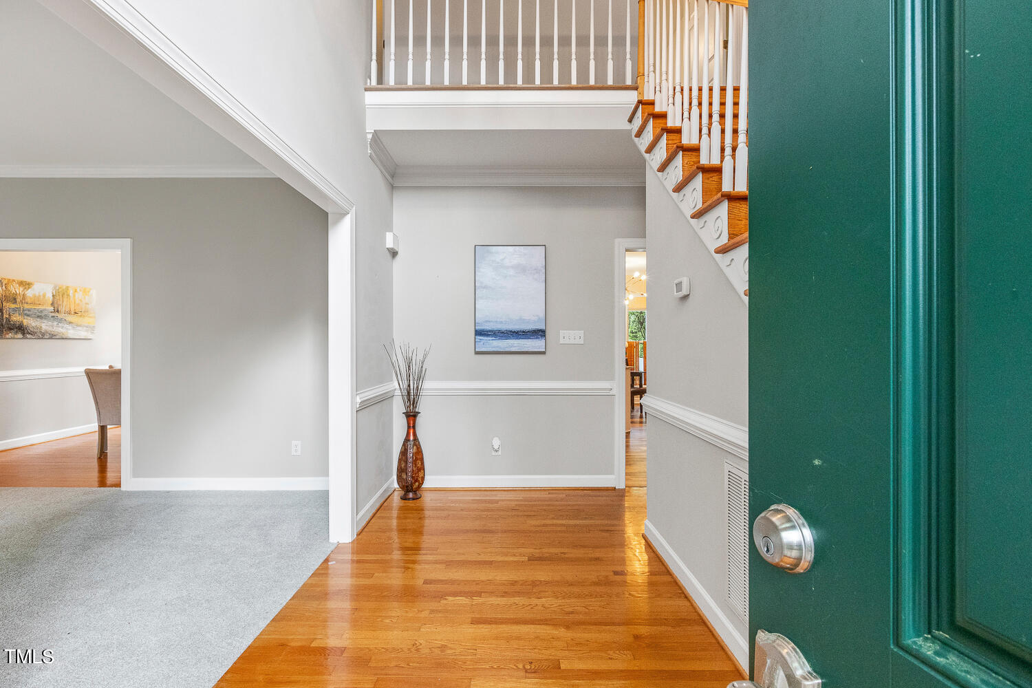 4604 Troone Court Raleigh, NC 27612 - Photo 4 of 54 a view of a hallway with wooden floor and a dining room