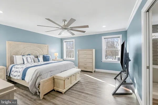 a spacious bedroom with a bed and a chandelier