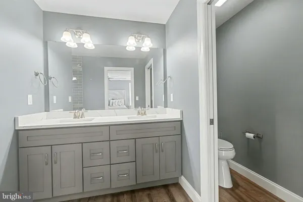 a bathroom with a double vanity sink and a mirror