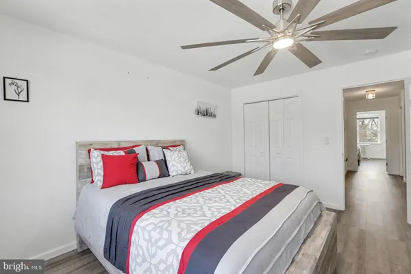 a bedroom with a large bed and a chandelier