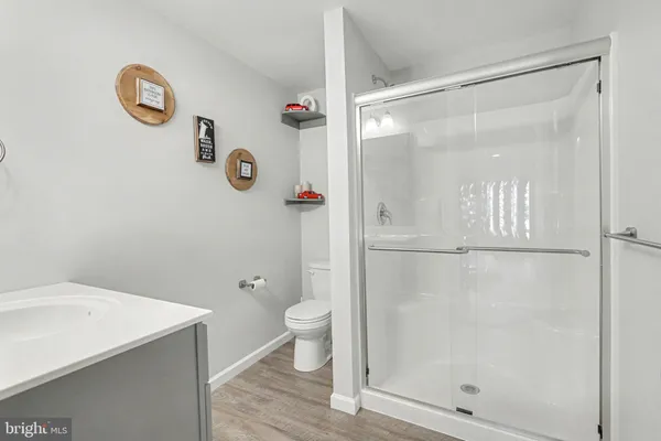 a bathroom with a shower a toilet and a sink