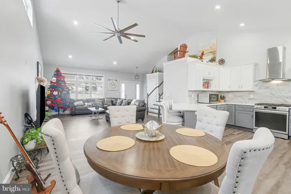 a living room with furniture and kitchen view