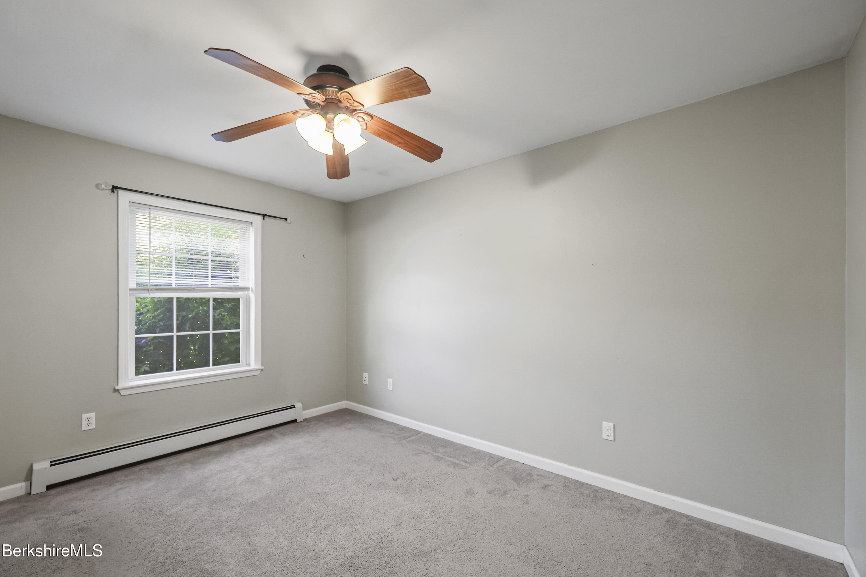29 Balance Rock Road Lanesborough, MA 01237 - Photo 18 of 38 an empty room with window and ceiling fan