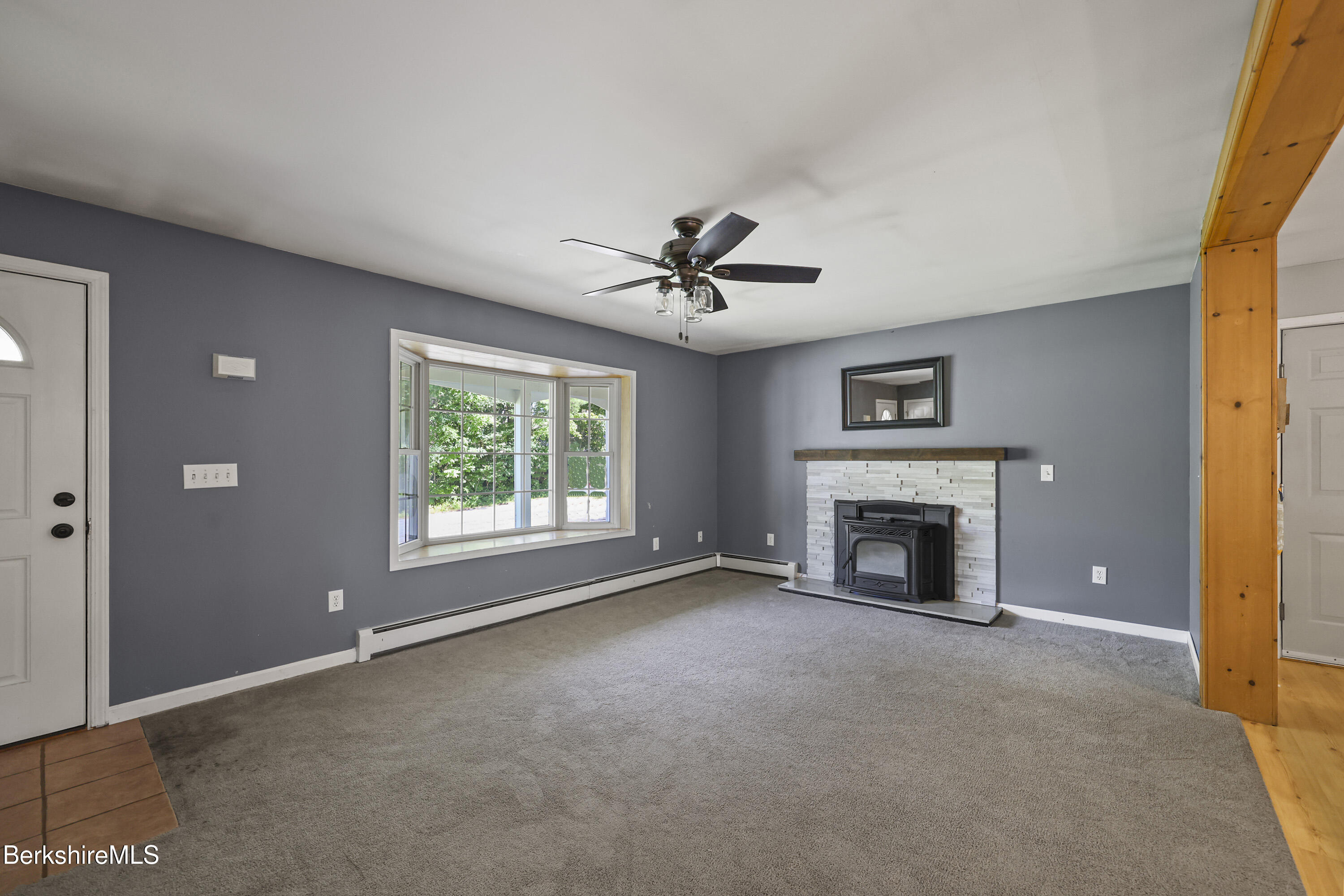 29 Balance Rock Road Lanesborough, MA 01237 - Photo 5 of 38 a view of a livingroom with a fireplace and a ceiling fan