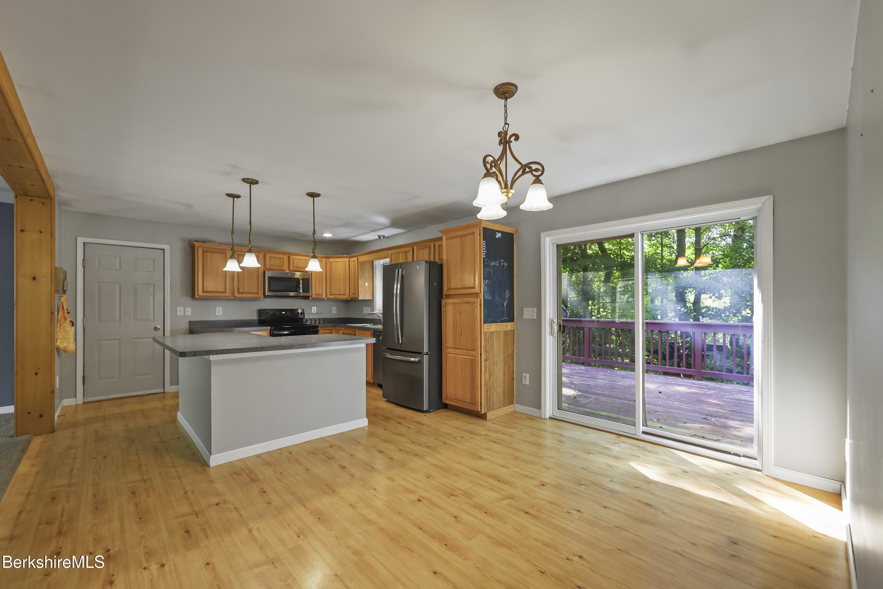 29 Balance Rock Road Lanesborough, MA 01237 - Photo 9 of 38 a open kitchen with a refrigerator a sink dishwasher a dining table and chairs with wooden floor