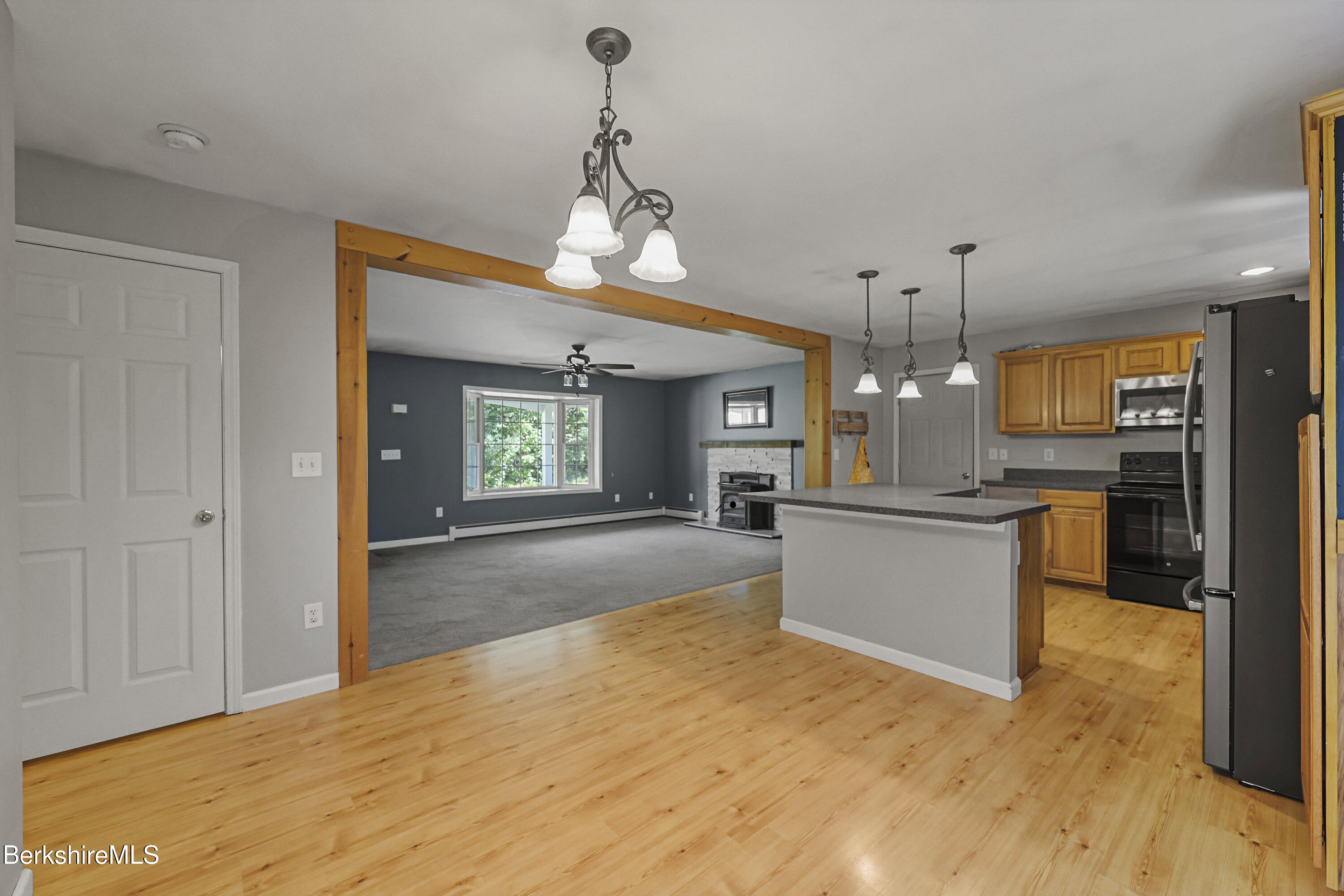 29 Balance Rock Road Lanesborough, MA 01237 - Photo 10 of 38 a large kitchen with a refrigerator a sink dishwasher a oven and a dining table with wooden floor