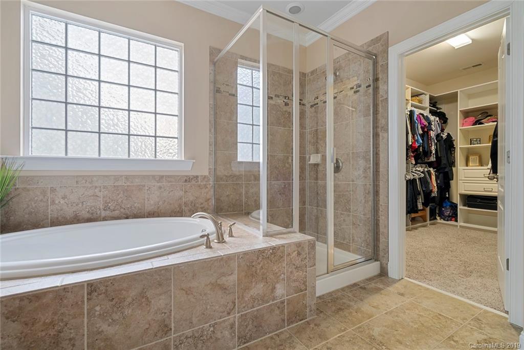 730 Falcon Ridge Fort Mill, SC 29708 - Photo 14 of 31 a spacious bathroom with a tub and a shower