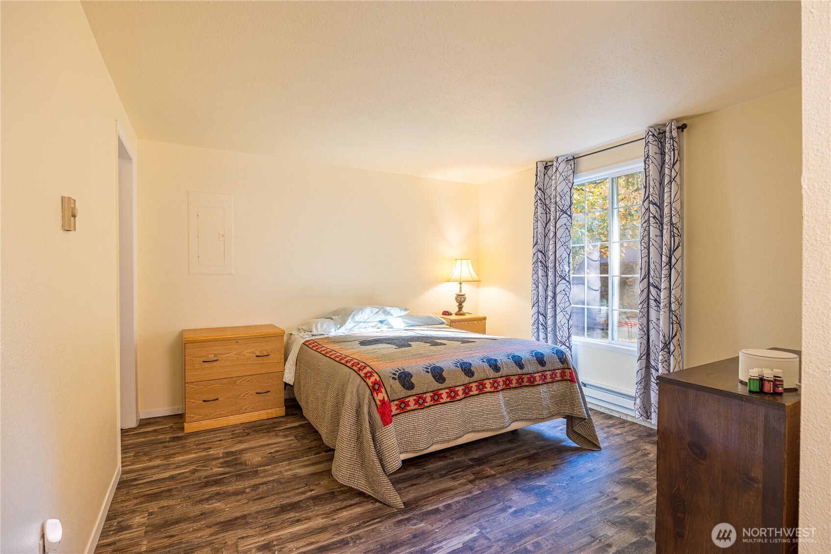 2095 Bear Creek Road Port Angeles, WA 98363 - Photo 11 of 39 a bedroom with a bed and wooden floor