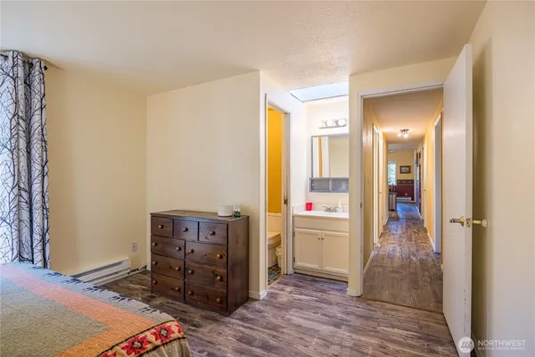 a view of a bedroom with furniture and wooden floor