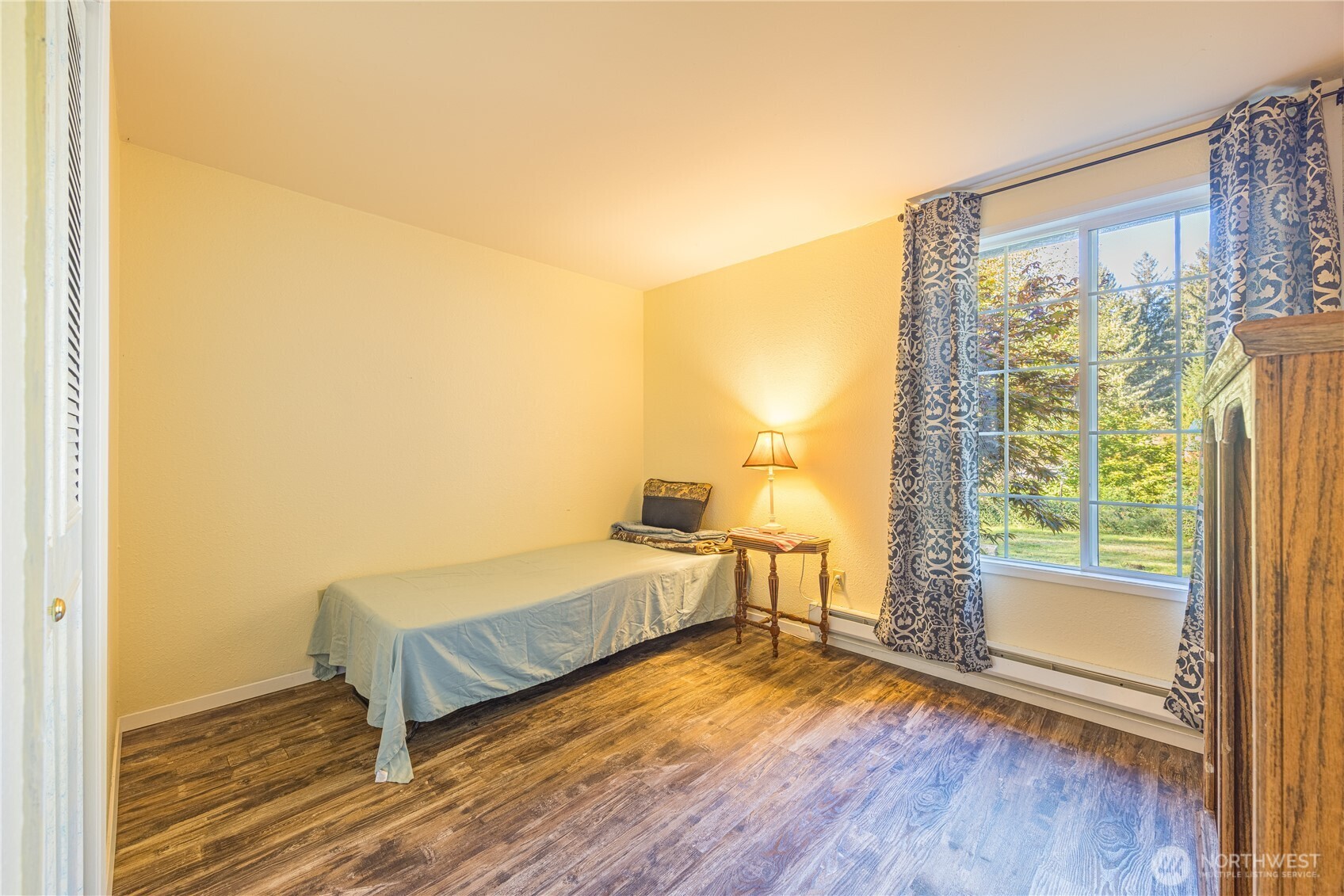2095 Bear Creek Road Port Angeles, WA 98363 - Photo 15 of 39 a spacious bedroom with a bed and wooden floor
