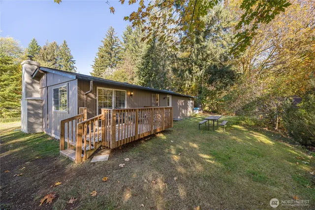 a view of a yard with wooden fence and a bench
