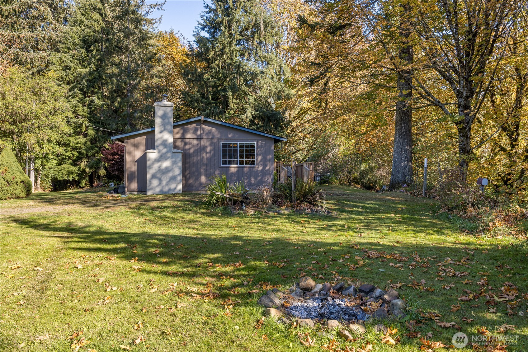 2095 Bear Creek Road Port Angeles, WA 98363 - Photo 22 of 39 a front view of a house with a yard table and chairs