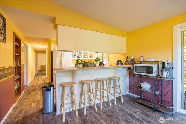 a dining room with furniture and a floor to ceiling window