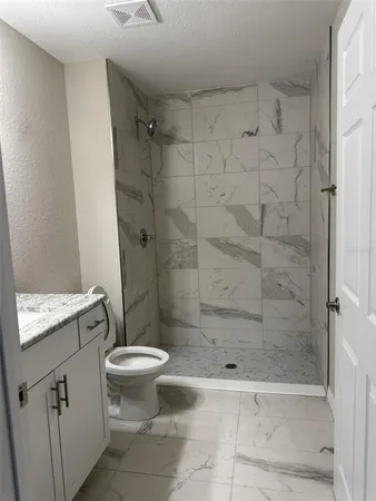 a bathroom with a shower and a toilet